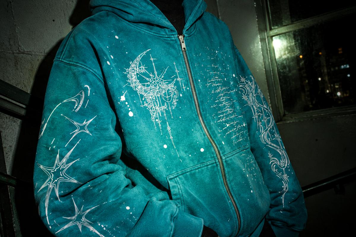 Look 005 — Blue Hour zip hoodie, close-up of the chest artwork, zipper and sleeves under direct flash.