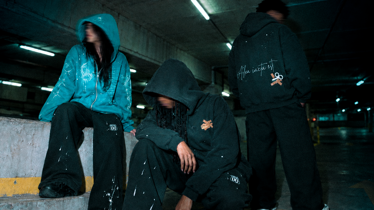 Look 010 — Three models wearing Blue Hour, Alea and Route 00 in a concrete parking structure.